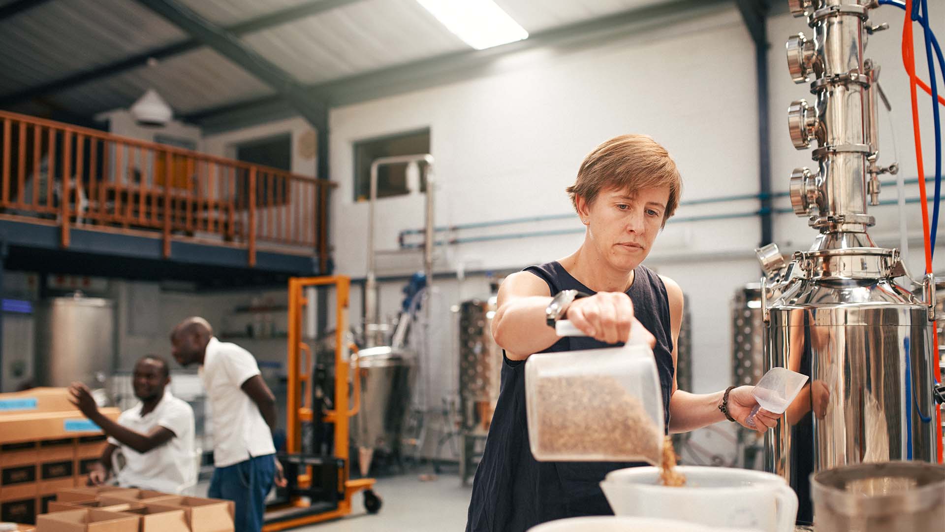 barley_processing A woman measuring out barley for processing